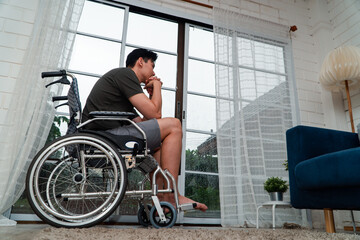 A disabled man sitting in a wheelchair is disappointed and Desperate to heal after car accident. Concept of Careless Driving, Insurance and Mental health care After the accident