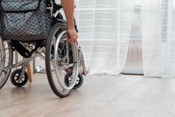 A disabled man sitting in a wheelchair is disappointed and Desperate to heal after car accident. Concept of Careless Driving, Insurance and Mental health care After the accident