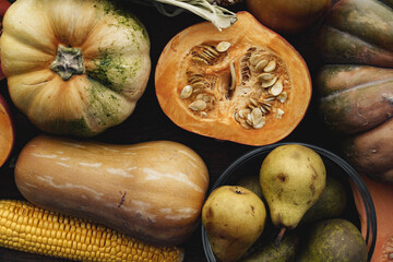 Pumpkin and pears autumn harvest on wooden table