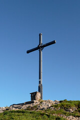 Summit cross of Seelekopf mountain at panorama hiking tour Nagelfluhkette, Bavaria, Germany