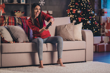 Photo of young attractive beautiful cheerful smiling excited crazy woman sit sofa play video games...