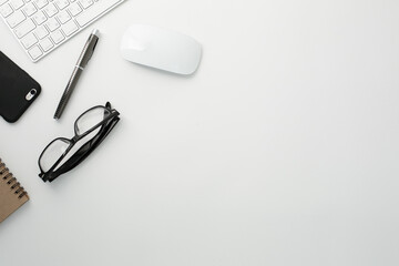 Office workplace with keyboard, notepad, glasses telephone and pen
