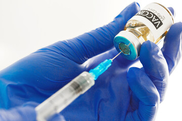Doctor hands holding covid-19 vaccine preparing for vaccination of a patient