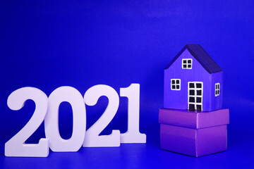 Home Property 2021 , 2021 number wood with House model on Blue background - home new year - Blue concept of Real Estate, Property for Sale and rent