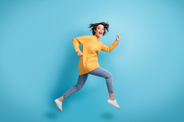 Fototapeta na wymiar Full length body side profile photo of funny female runner laughing jumping up hurrying isolated on bright blue color background