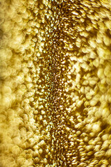 Gold dust background blurred, small gold dust reflects light