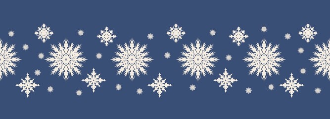 Seamless Christmas pattern of white snowflakes on a dark blue background. Template for design