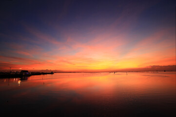 Fototapeta na wymiar Dramatic or magic sunset sky over beach bridge at Chonburi, Thailand