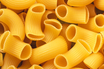 Dry pipe rigati pasta backround. Closeup view.