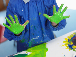 Boy With Painted Hands In Art Class