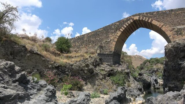 Medieval bridge of Adrano, Sicily, of arabic origin and saracen. Called Simeto river  lava gorges. Video 4k