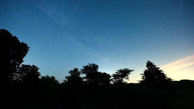 Timelapse Of A Push Through A Window Surrounded By Christmas Lights To Reveal Stars In A Clear Night Sky With Silhouette Trees In The Foreground