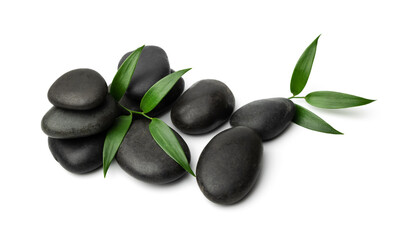 Obraz na płótnie Canvas massage stones isolated on white background with green leaf. lastone therapy