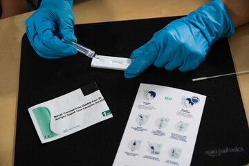 Test antigénique pour Covid-19 par une infirmière asiatique.
