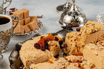 Halva with dried fruits on arabic dishware