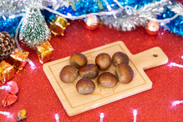 Christmas Decorations and Chestnuts on wooden board for food presentation