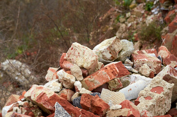 a pile of bricks among the ruins of a factory