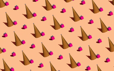 Christmas tree in the form of a cone and a pink gift on a beige background.