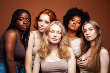 Obraz premium young pretty caucasian, afro, scandinavian woman posing cheerful together on brown background, lifestyle diverse nationality people concept