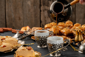 Cup of coffee and turkish pastries on dark surface