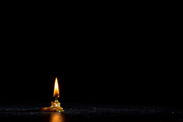 Burning out wax candle on a dark background.