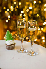 Champagne glasses and the lights on christmas tree