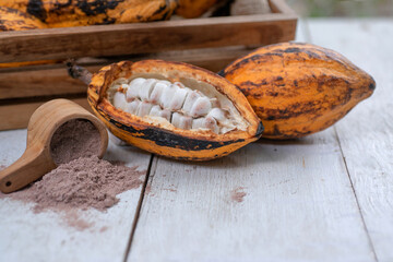 Fresh Cacao fruit with pulp and seeds on wooden table and crate, selective focus, Cacao fruits...