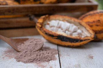Fresh Cacao fruit with pulp and seeds on wooden table and crate, selective focus, Cacao fruits which is used as raw material to make chocolate
