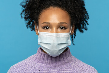 Close up studio portrait of Afro American woman wear face medical mask during covid-19, coronavirus...