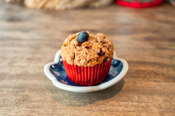 Homemade baked blueberry muffin on wooden table