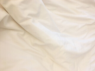 Unmade bed; wrinkled pillowcases, bed sheet and duvet