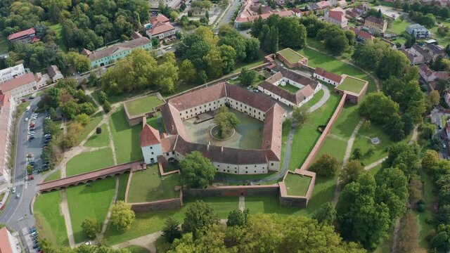 Sarvar, Hungary - 4K drone flying around the famous Castle of Sarvar (Nadasdy castle) on a sunny summer day with green trees. The town of Sarvar has been located in Vas county