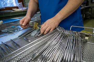 some Cleaned surgical instruments are sorted into an instrument tray