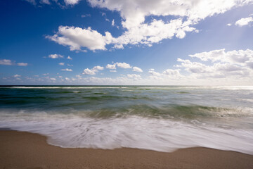 Fototapeta na wymiar 1 second exposure waves crashing on the beach
