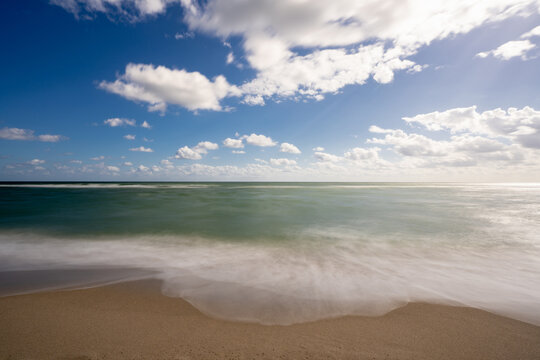 Beautiful 10 second long exposure photo waves crashing on the beach
