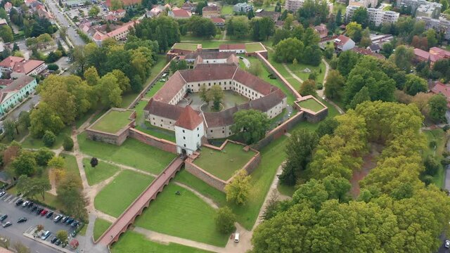 Sarvar, Hungary - 4K drone flying above the famous Castle of Sarvar (Nadasdy castle) on a sunny summer day with green trees. The town of Sarvar has been located in Vas county