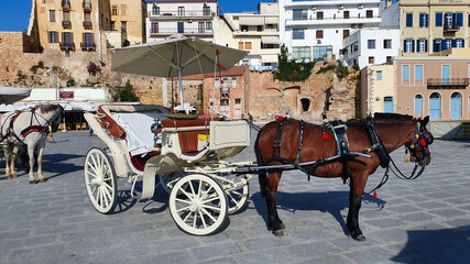 Fototapeta na wymiar Horse and Carriage at Venetian harbour of Chania, Crete, Greece.