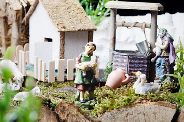 Christmas nativity scene - Jesus Christ, Mary and Joseph. Wooden figurines  in the background.
