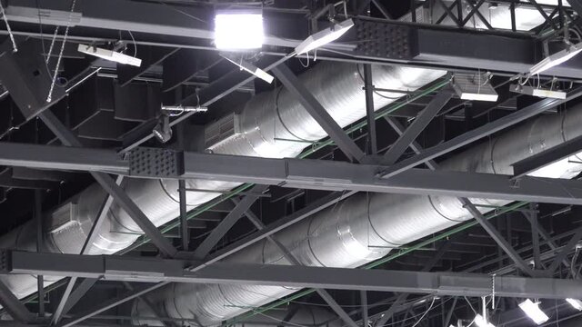 Panoramic video roof ceiling many metal beams structure, tubes, floodlights.