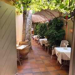 Typical small Greek atmospheric restaurants in the middle of the city. Colorful chairs and tables...