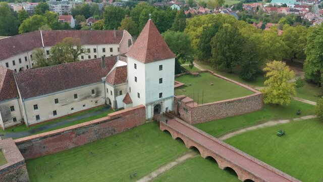 Sarvar, Hungary - 4K drone flying by the famous Castle of Sarvar (Nadasdy castle) on a sunny summer day with green trees and blue sky. The town of Sarvar has been located in Vas county