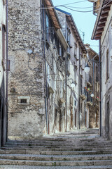 Fototapeta na wymiar old houses on bending uphill stepped lane, Scanno, Abruzzo, Italy