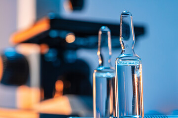 Medical vial with medication near microscope photo