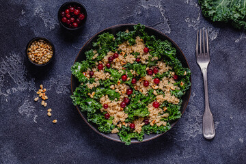Healthy raw kale and quinoa salad with cranberry and pine nut.