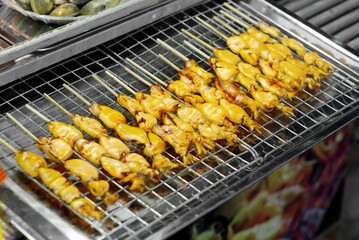 Grilled Squid Skewers at the walking street market in Thailand Local food market, Cheap food (selective focus)