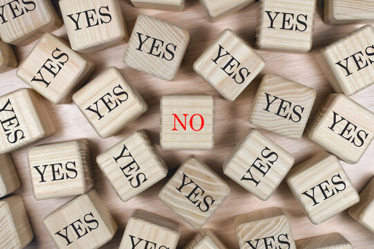 Positivity and decision making concept with Yes and No words on wooden blocks