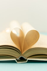 Heart from book pages. vintage style with bokeh in soft light blur background ,copy space, concept for valentine's day.