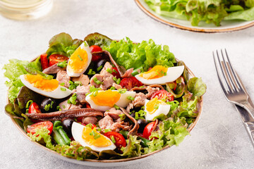 salad Nicoise with tuna, eggs, green beans, tomatoes,  olives, lettuce and anchovies