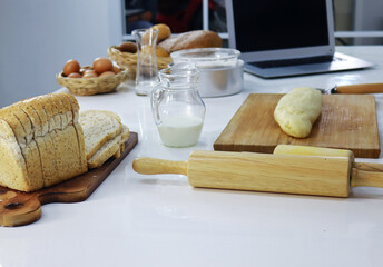 Obraz na płótnie Canvas Bread glass milk and eggs and kitchen baking utensils