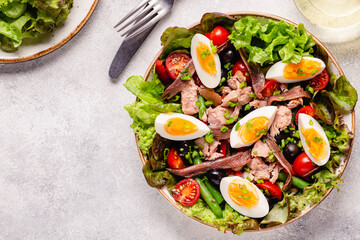 salad Nicoise with tuna, eggs, green beans, tomatoes,  olives, lettuce and anchovies